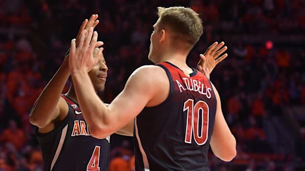 Dec 11, 2021; Champaign, Illinois, USA; Arizona Wildcats guard Dalen Terry (4) and teammate Arizona Wildcats forward Azuolas Tubelis (10) celebrate a 83-79 win over the Illinois Fighting Illini at State Farm Center. Mandatory Credit: Ron Johnson-USA TODAY Sports